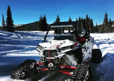 Always Peak Powder Club0A polaris rzr with snow tracks adventure awaits